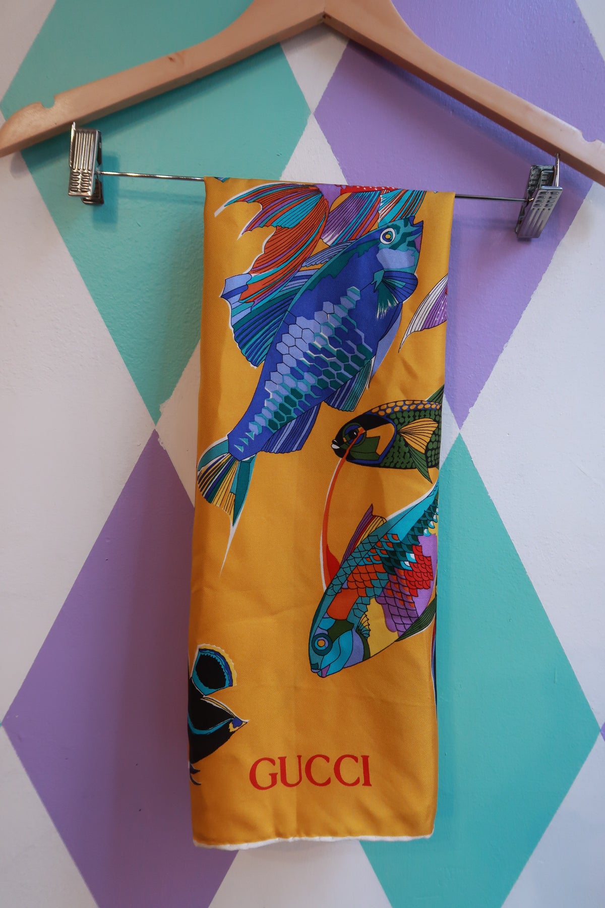 Vintage Gucci silk tropical fish scarf in golden yellow with multicolor fish design, lightweight and luxurious designer silk accessory.