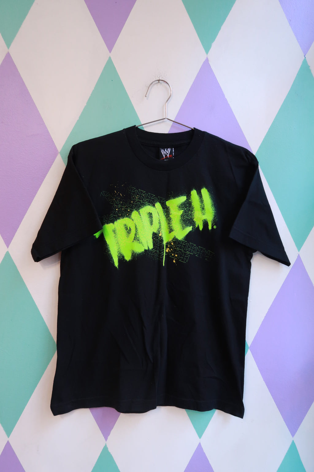 Men's black Vintage WWE Triple H graphic T-shirt by Elektra Vintage featuring neon wrestling design and classic WWE logo.