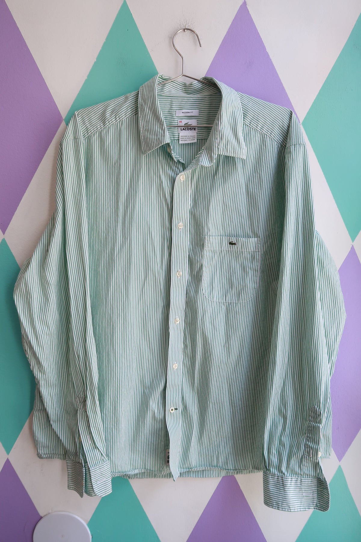 Men's Lacoste green and white striped button-up shirt from Elektra Vintage, featuring a classic collar and long sleeves.