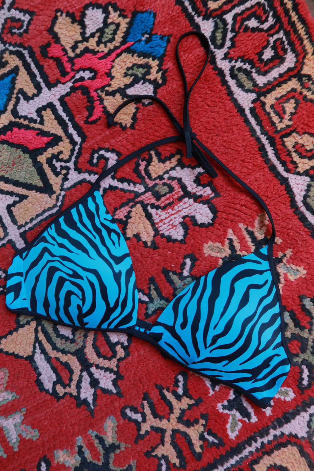 Vintage 2000s Elektra Pink and Blue Zebra Print String Bikini Top laid flat, showing its vibrant pattern and adjustable ties.
