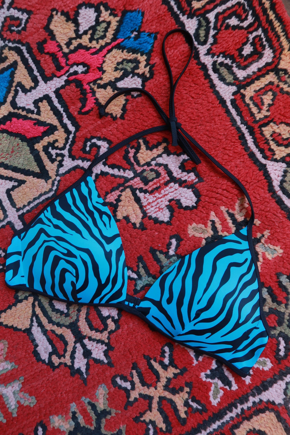 Vintage 2000s Elektra Pink and Blue Zebra Print String Bikini Top laid flat, showing its vibrant pattern and adjustable ties.