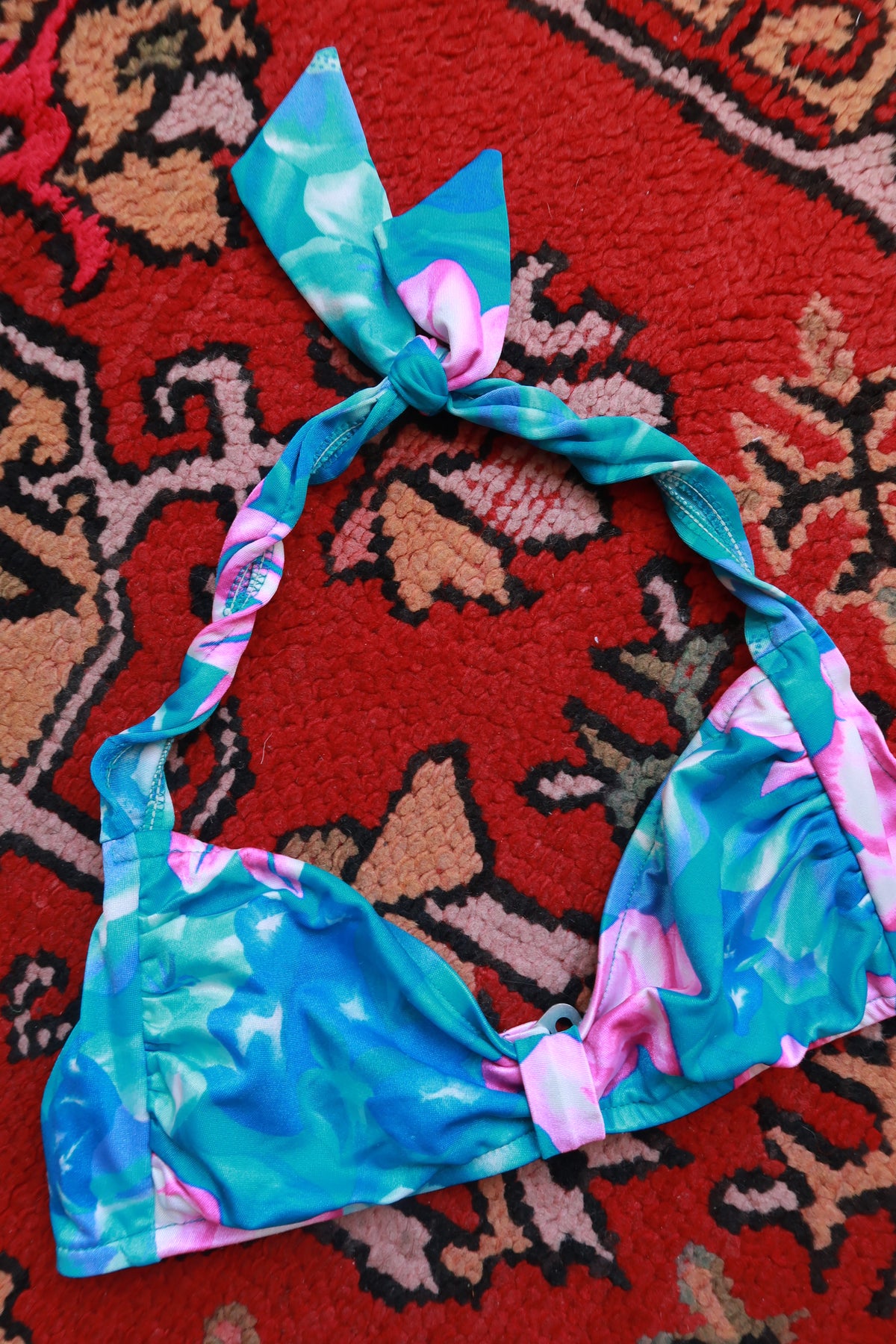 Vintage tropical floral halter bikini top by Elektra Vintage, featuring colorful floral print and tied halter neck design.