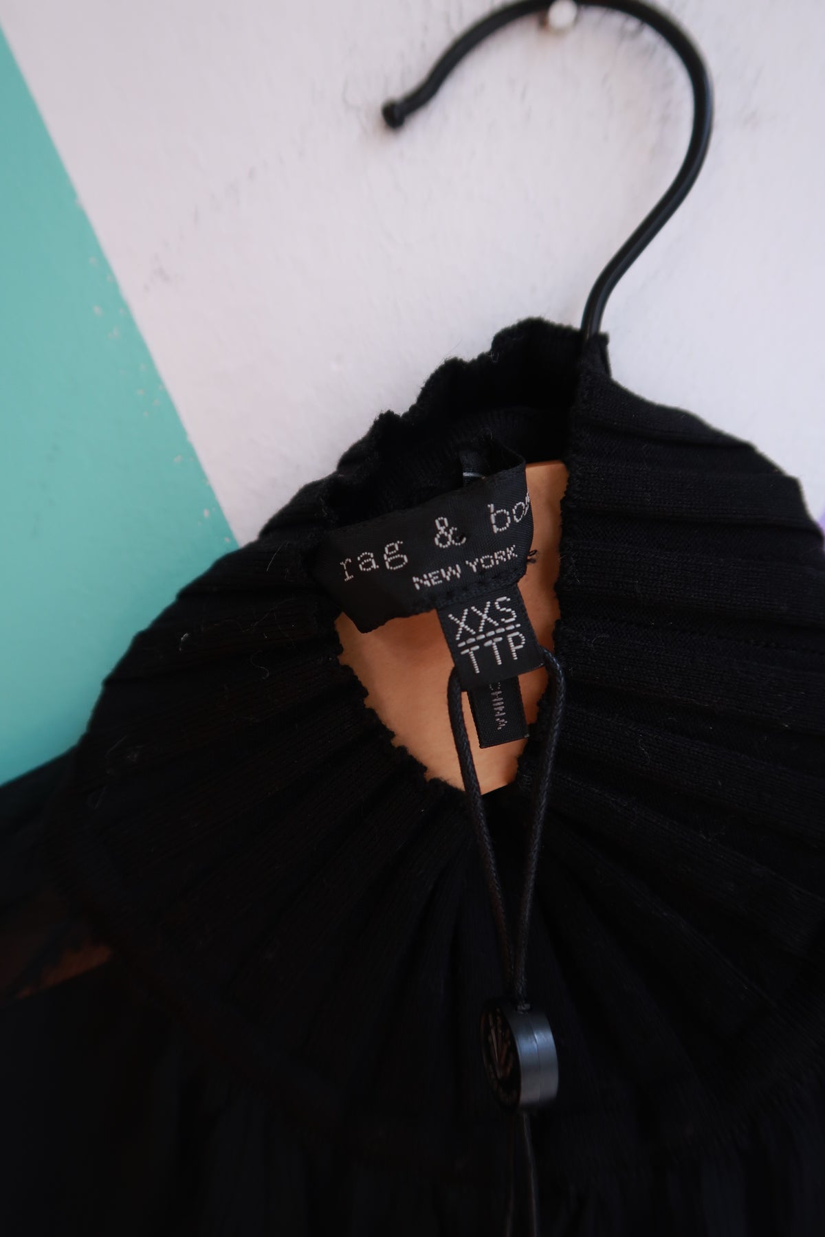 Black silk midi dress by Rag & Bone, sheer design, brand Elektra Vintage, displayed on a hanger with elegant detailing.