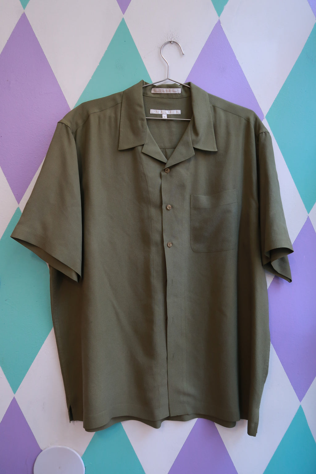 Men's vintage Perry Ellis silk olive camp shirt from Elektra Vintage, featuring a relaxed fit and classic collar.
