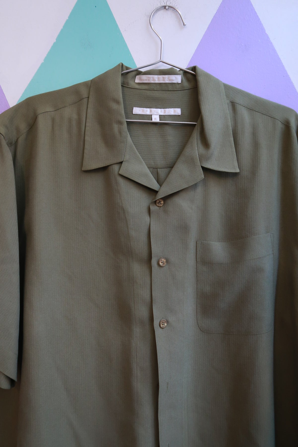 Men's vintage Perry Ellis silk olive camp shirt from Elektra Vintage, featuring a classic collar and button-front design.