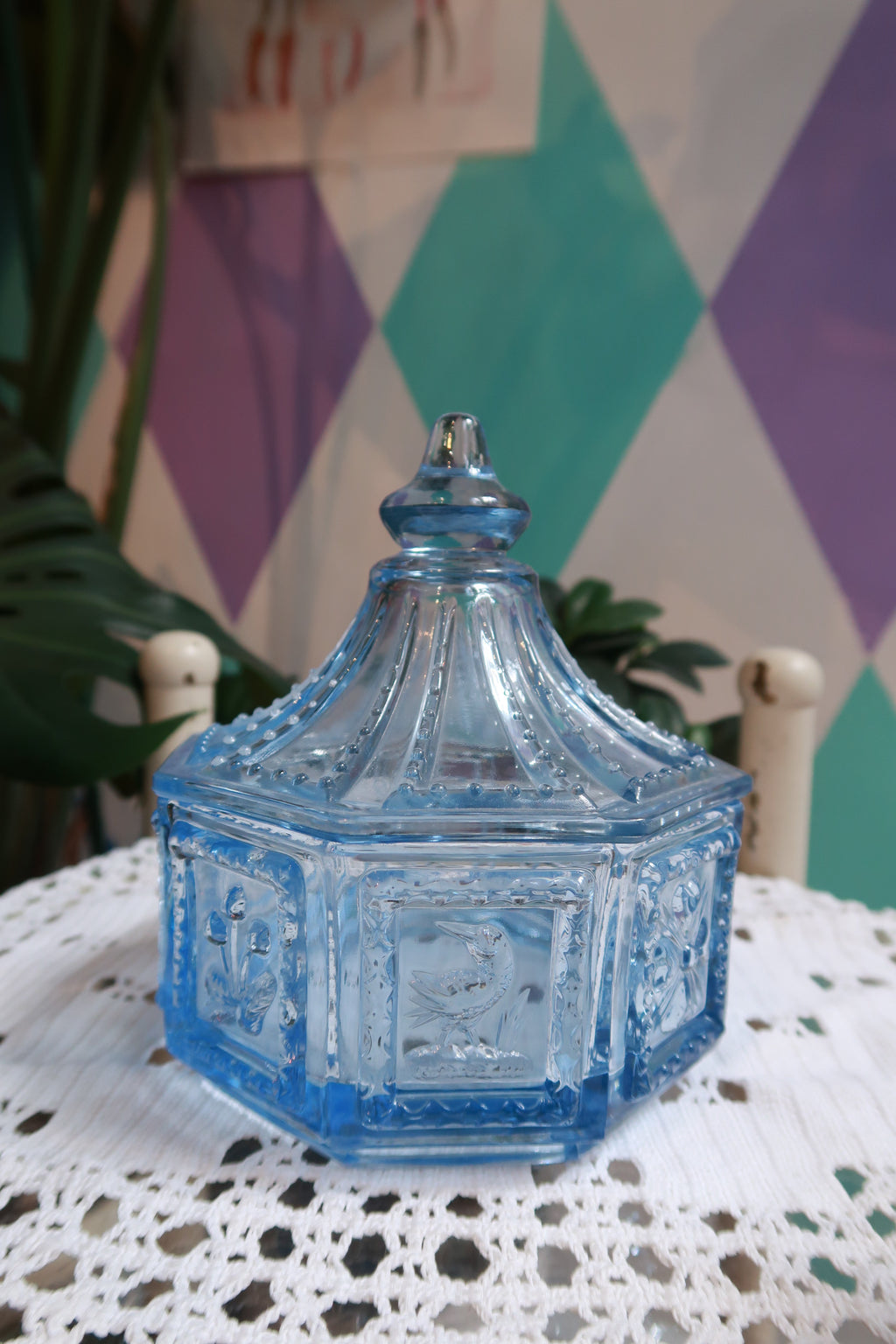 Vintage blue glass Elektra Vintage trinket box and candy dish with ornate floral design and scalloped edges.