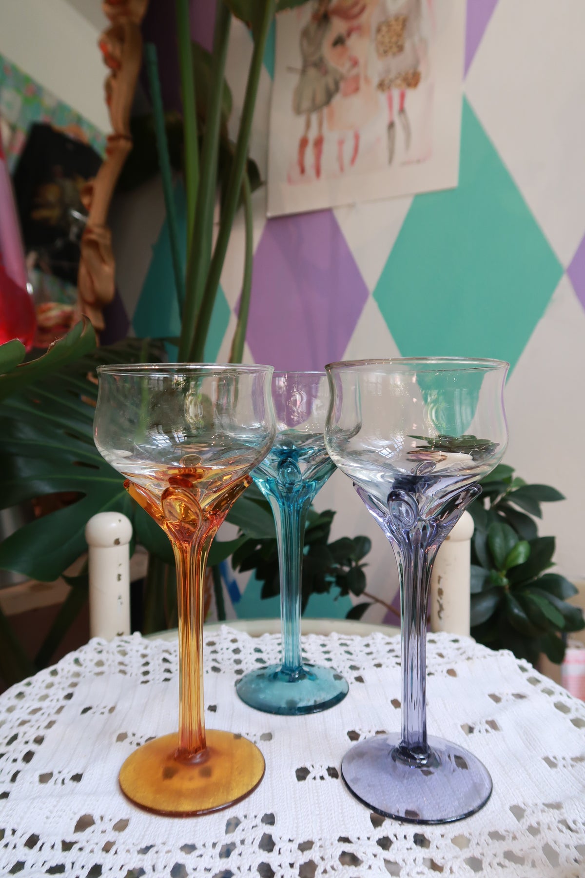 Set of vintage colored stem cocktail glasses in amber, blue, and purple by Elektra Vintage, featuring elegant wine glass designs.