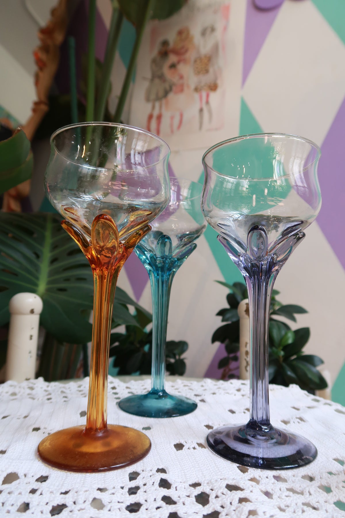 Set of vintage colored stem cocktail glasses in amber, blue, and purple by Elektra Vintage, showcasing elegant wine glass designs.