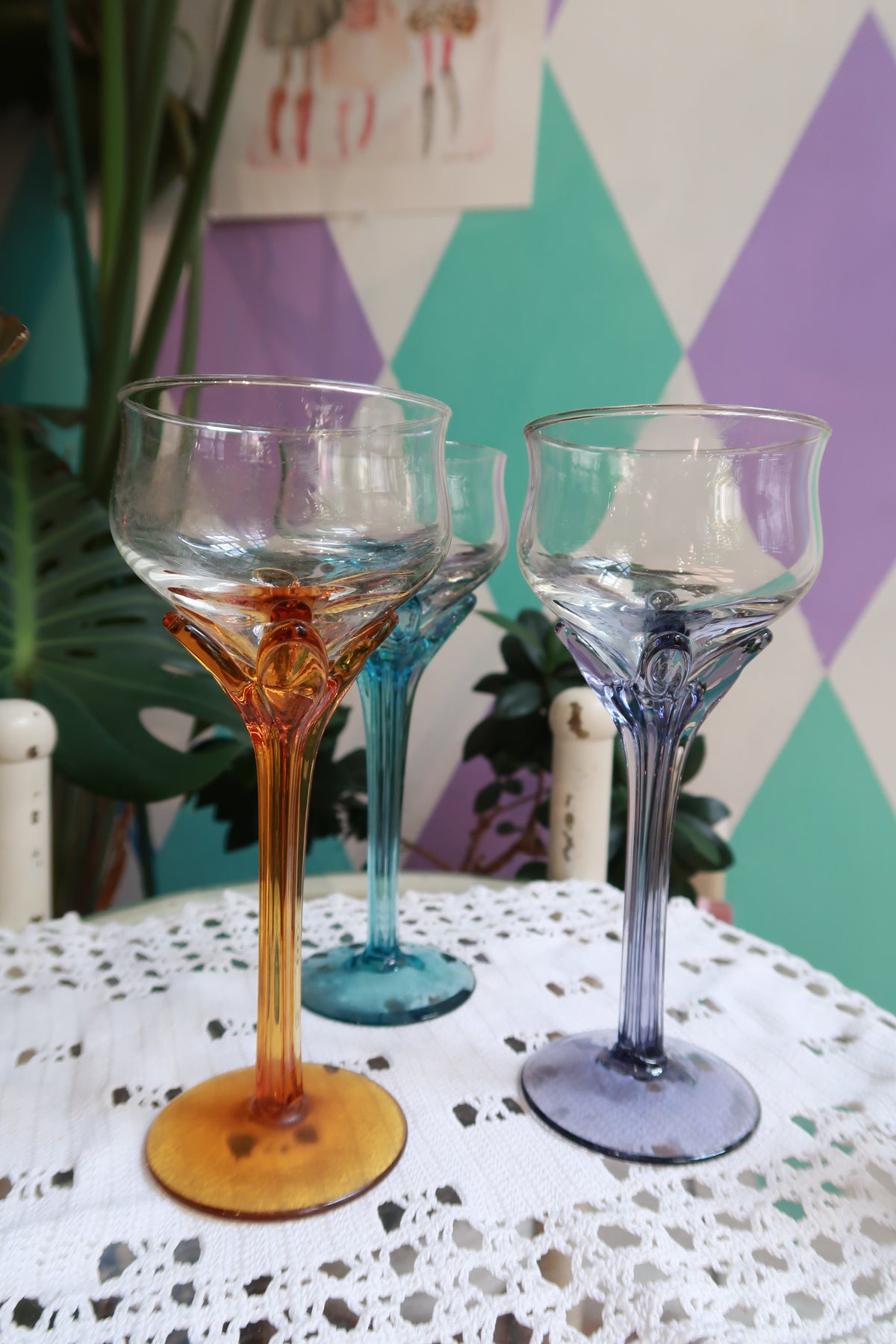 Set of vintage colored stem cocktail glasses in amber, blue, and purple by Elektra Vintage, showcasing elegant wine glasses.