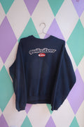 Vintage 2000s Quiksilver embroidered logo crewneck sweatshirt in navy, featuring classic branding and soft knit fabric.