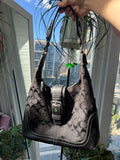 Black leather Hamilton Hobo shoulder bag by Coach, featuring a sleek design and spacious interior for everyday use.