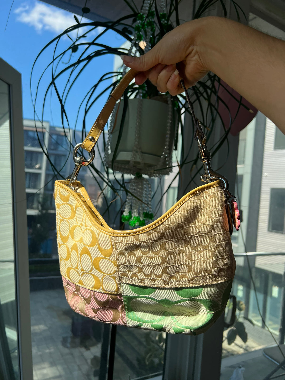 Vintage patchwork multicolor Coach shoulder bag by Elektra Vintage, featuring a classic design with vibrant fabric patches.
