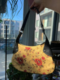 Vintage yellow flower print purse with leather accents by Elektra Vintage, showcasing its floral design and stylish features.