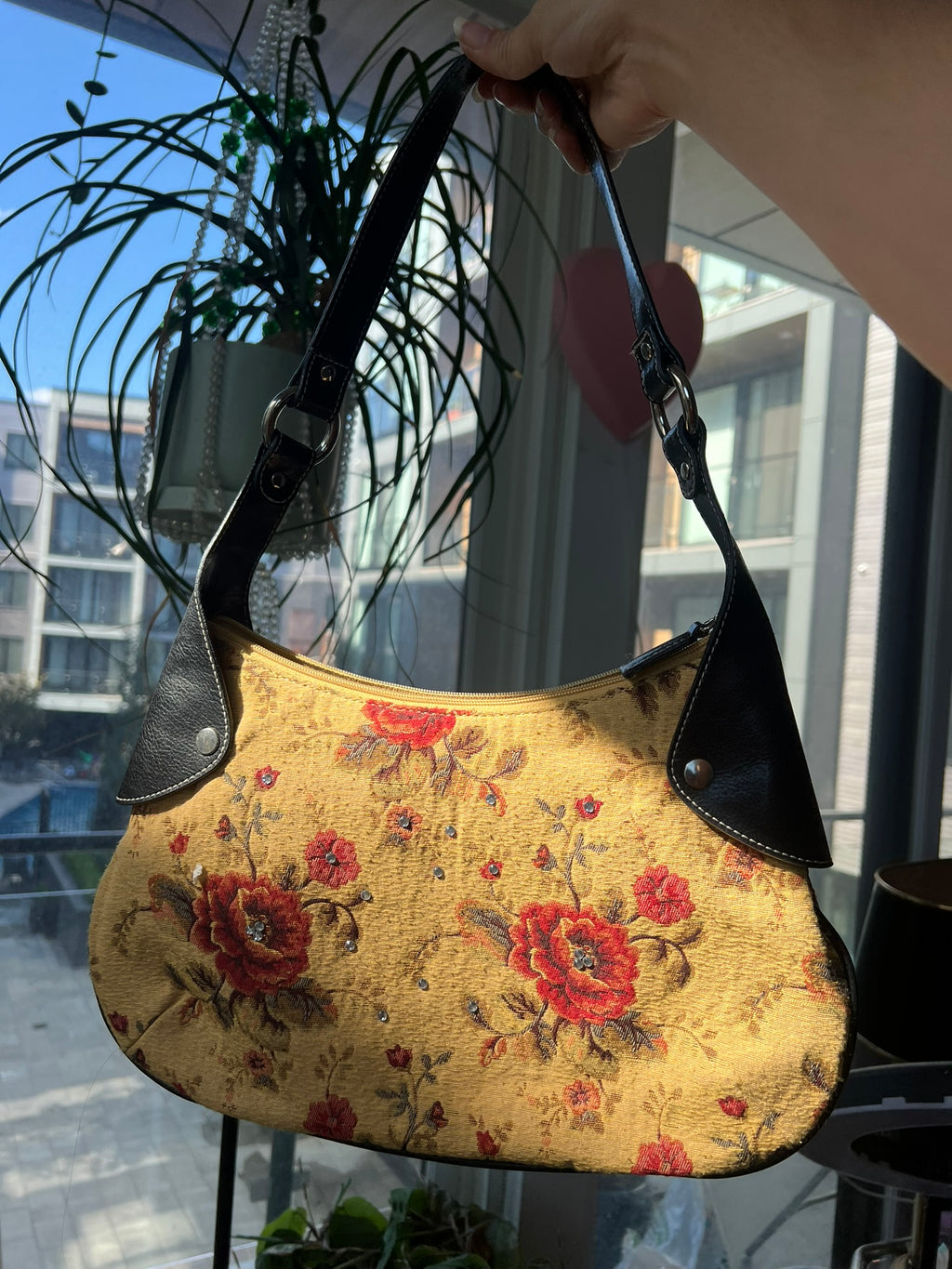 Vintage yellow flower print purse with leather accents by Elektra Vintage, showcasing a vibrant floral design and stylish silhouette.